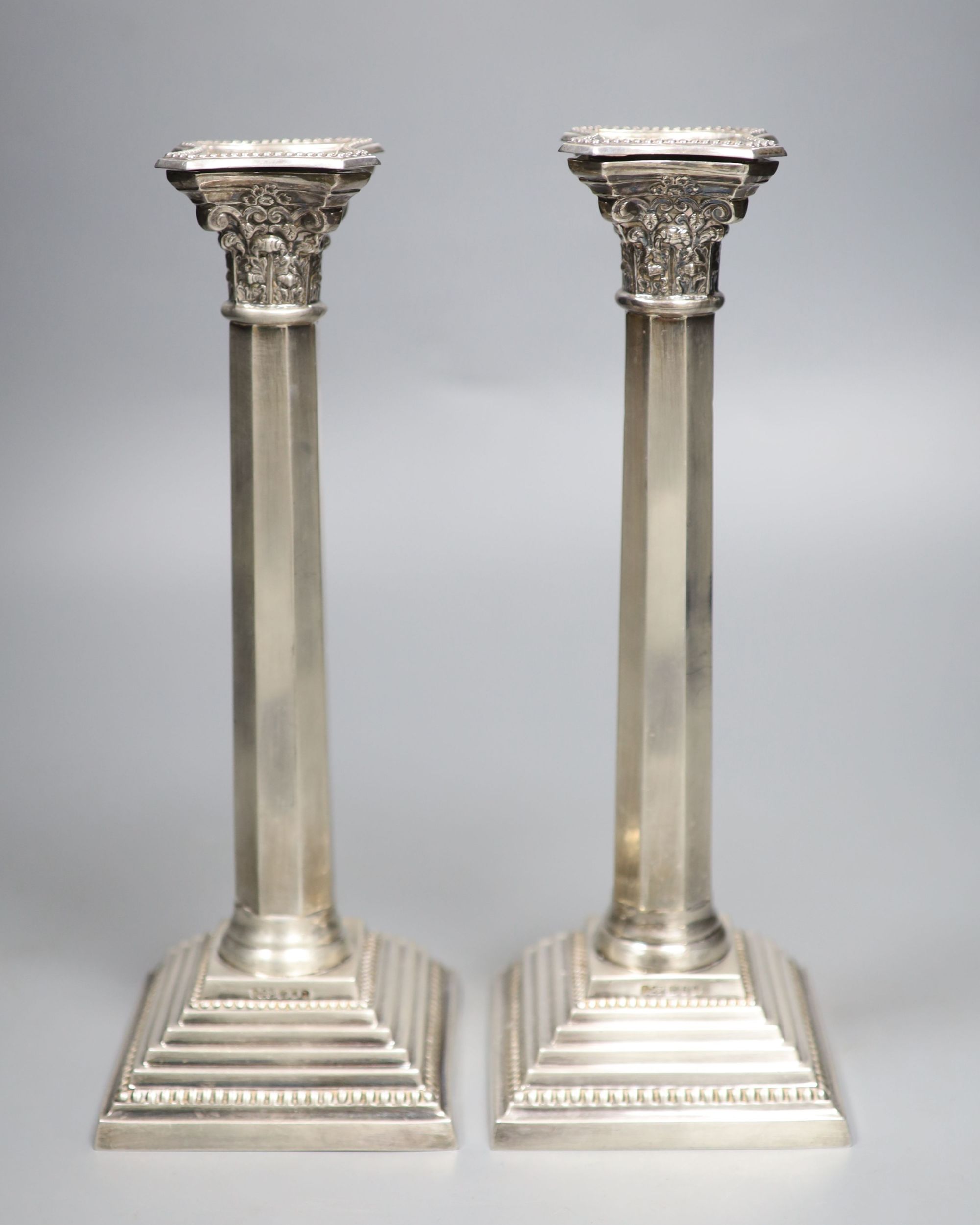 A pair of modern silver candlesticks, with panelled stems, A. Taite & Sons Ltd, London, 1957, height 27.9cm, 20.5oz.